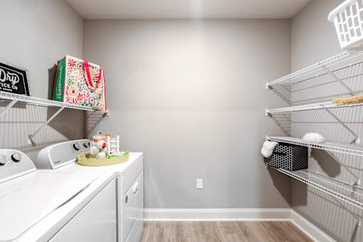 A kitchen pantry with white appliances and shelves.