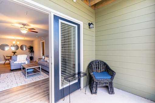 A patio with a chair and a table.