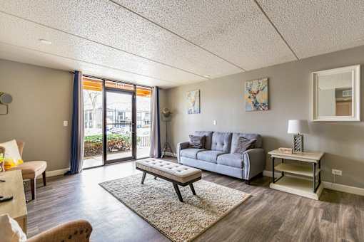 A living room with a grey sofa and a coffee table.