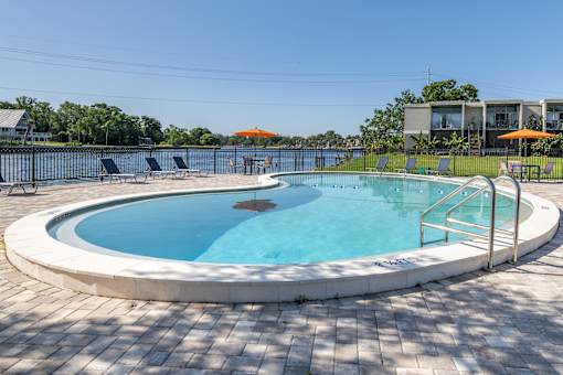 A round swimming pool with a white border and blue water.