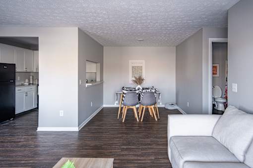A modern kitchen with a dining table set for two.