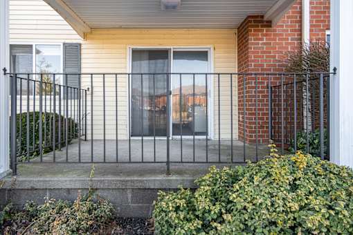 A house with a black iron fence and a brick wall.