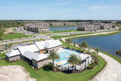 A resort with a swimming pool and palm trees.