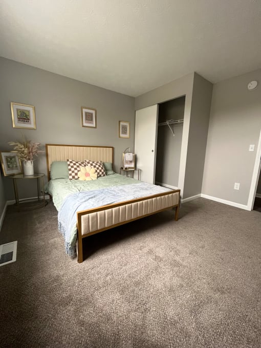 a bedroom with a bed and a closetat Centerpointe Apartments, New York