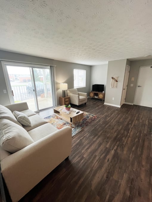 a living room with hardwood floors and a sliding glass doorat Centerpointe Apartments, Canandaigua, NY, 14424