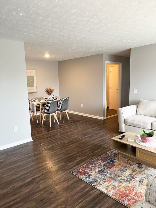 an open living room and dining room with a table and chairsat Centerpointe Apartments, Canandaigua, 14424