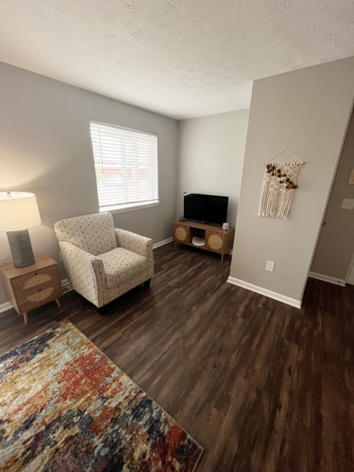 a living room with a tv and a chairat CenterPointe Apartments & Townhomes, Canandaigua, 14424