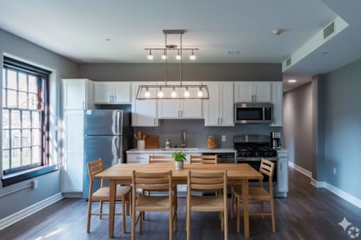 A modern kitchen with a dining table and chairs.