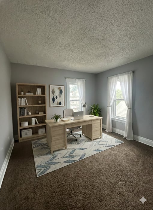 A room with a desk, chair, and bookshelf.