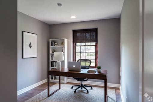 A room with a desk and a laptop on it.
