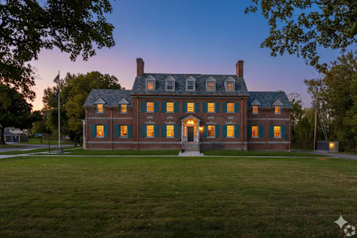 A large house with a flag on the left side.