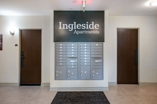 A wall of mailboxes is in front of a sign that says Ingleside Apartments.