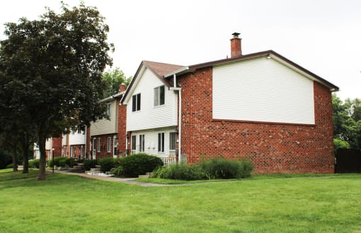 a row of houses with a green lawn in front of them