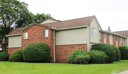 a house with a green lawn in front of it