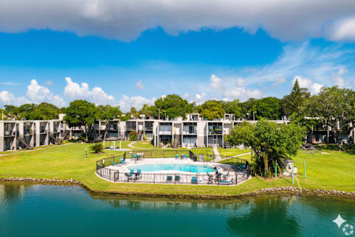 A large building with a pool in front of it.
