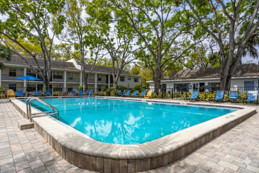 Pool With Relaxing Chairs at Fernwood Grove Apartments, Tampa, 33614