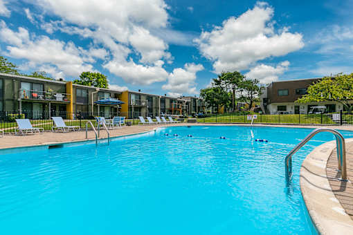 A large swimming pool with a few people in it.