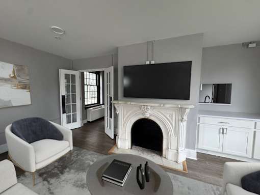 A living room with a fireplace and a television.