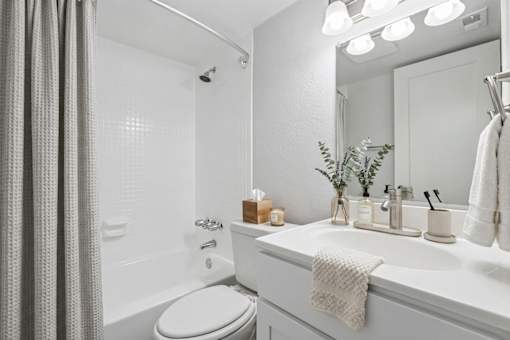 Bathroom with white vanity and tub shower combo at The Residences at Soho Apartments, Tampa