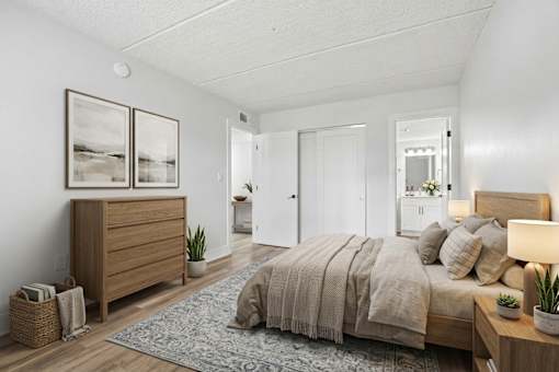 Primary bedroom with ensuite bathroom and wooden furniture at The Residences at Soho Apartments, Florida