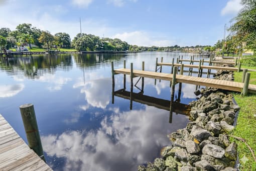 A wooden dock extends into a calm lake.