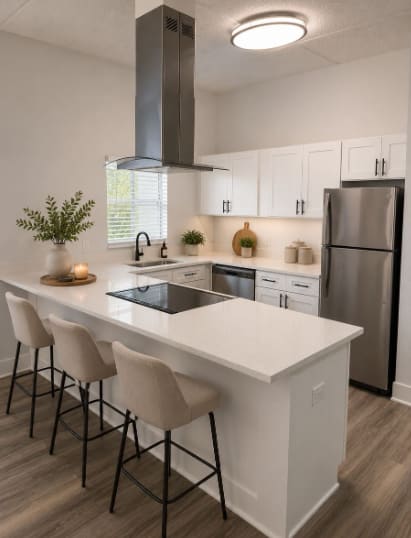 A modern kitchen with a white island and stainless steel appliances.