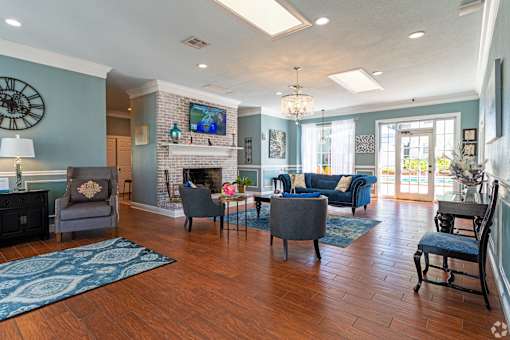 A living room with a fireplace and a television. at The Flats at Seminole Heights, Tampa, FL