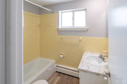 an empty bathroom with a sink toilet and tub