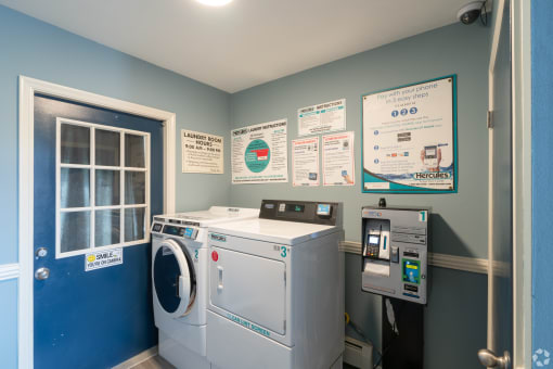 a laundry room with a washing machine and a door