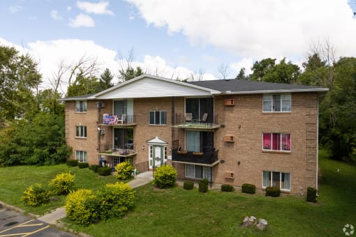 an aerial view of a brick apartment building with balconies