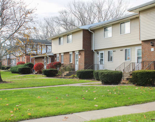 a row of houses on a sidewalk in a neighborhood at Willowbrooke Apartments, Brockport, New York