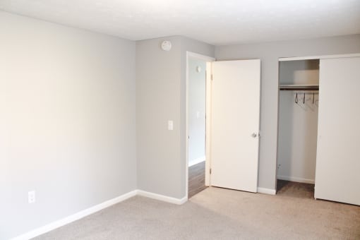 an empty room with a closet and a door to a bathroom at Willowbrooke Apartments, Brockport, 14420