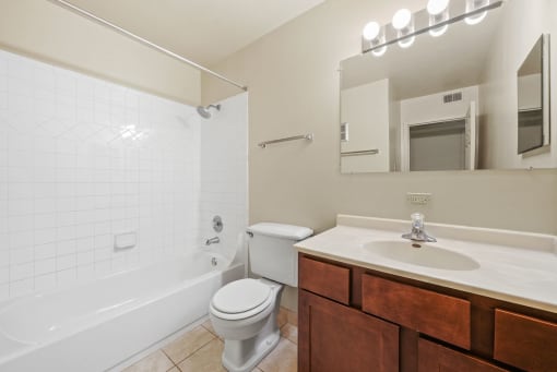 Bathroom with mirror and cabinets at Woodland Ridge Apartments in Woodridge, IL