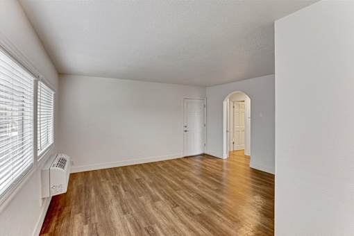 A room with wooden floors and white walls.