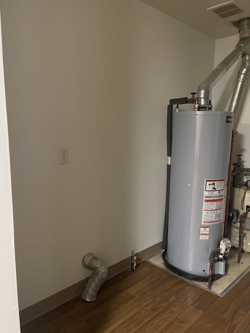 a view of the flooring in a room with a machine on the side of the room