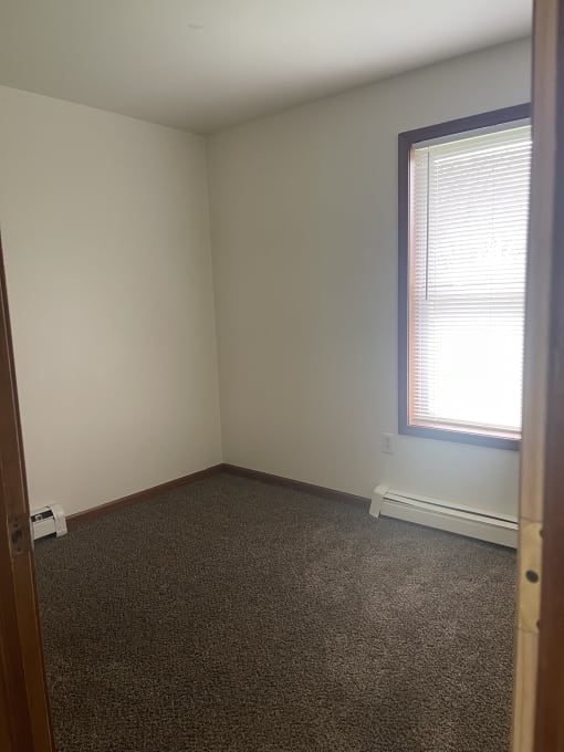 a small room with a skylight and a wooden floor