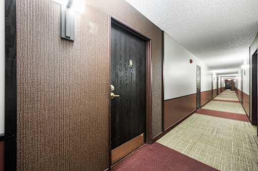 a hallway of elevators and doors
