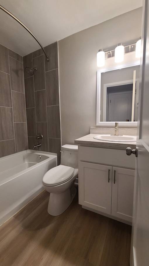 a small bathroom with a toilet sink and bath tub