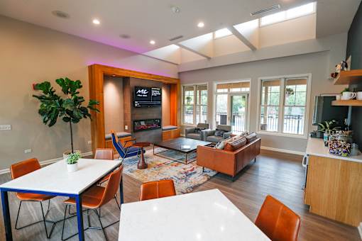 A living room with a white table and chairs.