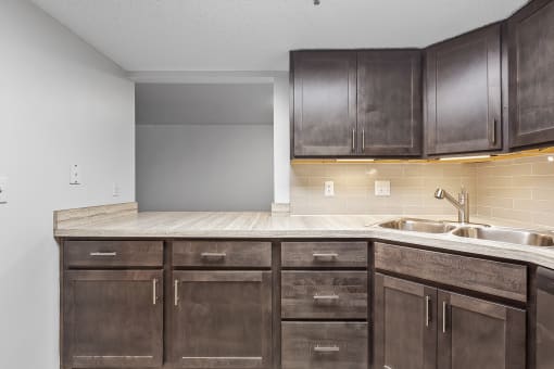 a kitchen with wooden cabinets and a sink