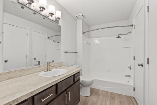 a bathroom with a toilet sink and shower