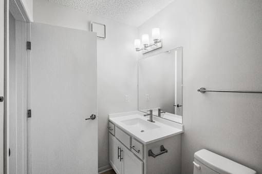 an empty bathroom with a sink and a mirror