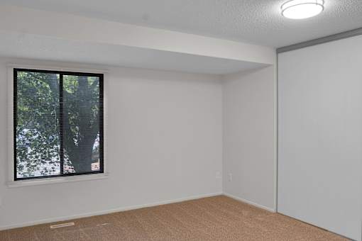 A room with a window and a closed door.
