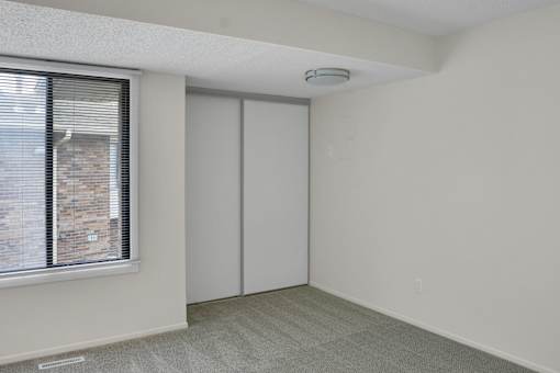 A room with a window and a sliding door.