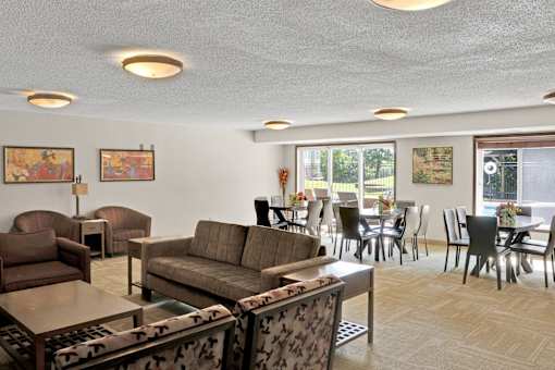 A living room with a couch, chairs, and a coffee table.