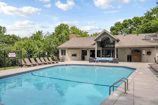 A pool with a building behind it.