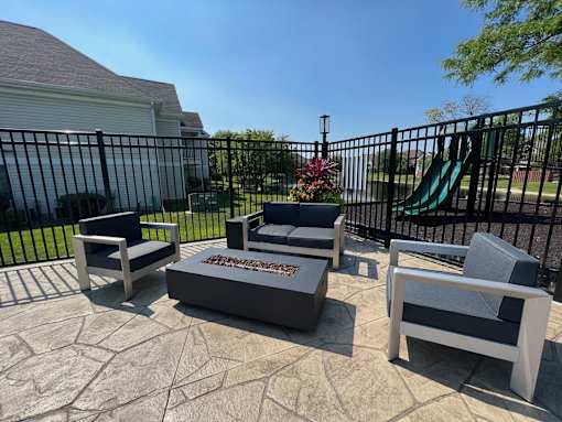 A set of outdoor furniture is arranged on a patio.