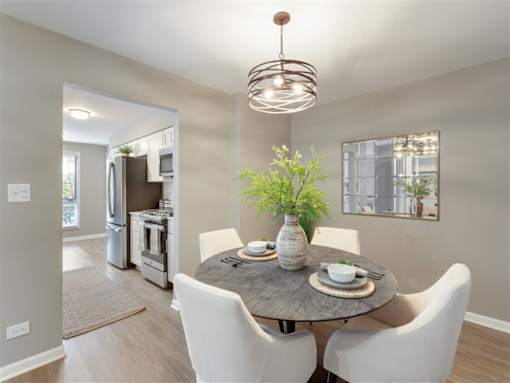 A modern dining room with a round table set for two.