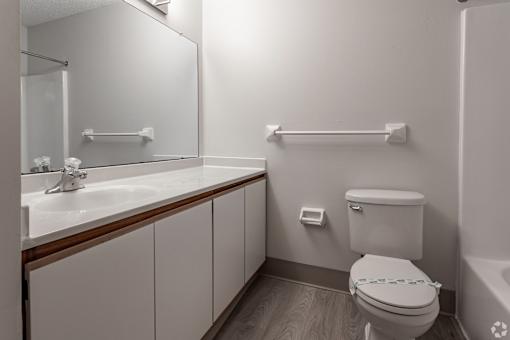 A white toilet with a blue towel in a bathroom.