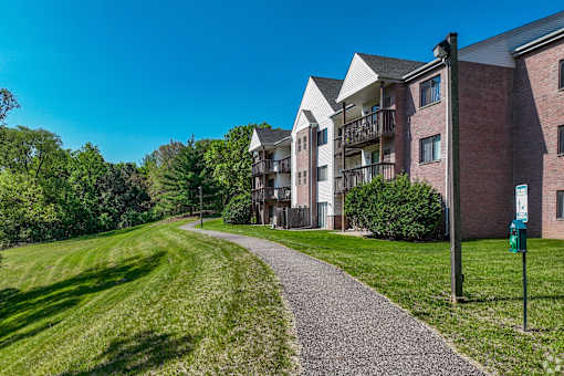 A pathway leads to a brick apartment building.